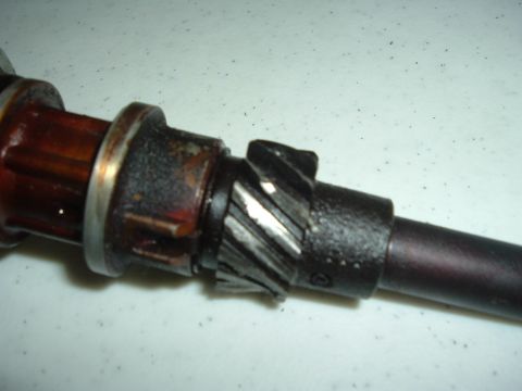 1993 Ford Taurus - A close-up view of a distributor gear, showing wear on its teeth and a silver retaining ring.