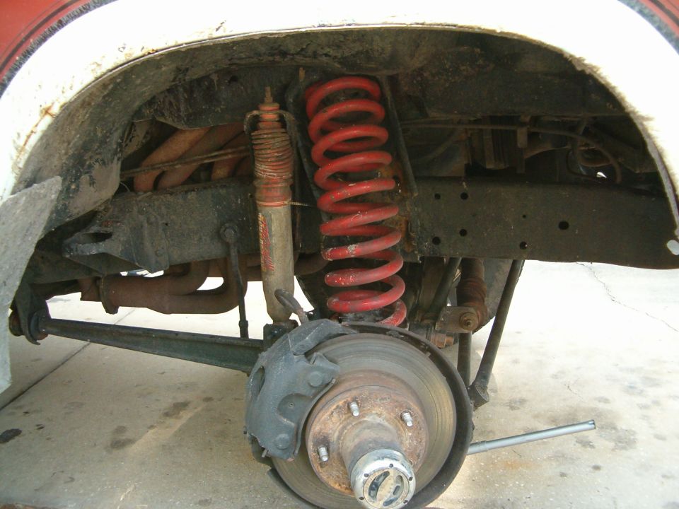 1979 Ford Bronco rear suspension and brake assembly with red coil spring