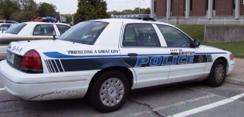 1991 Ford Crown Victoria LTD - A police car is parked next to another police car in a parking lot.