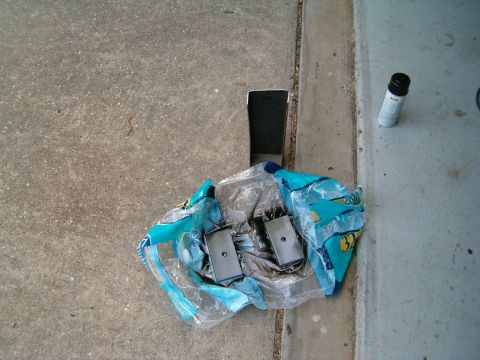 1979 Ford Bronco - Parts are laid out on a concrete surface next to a can of spray paint.