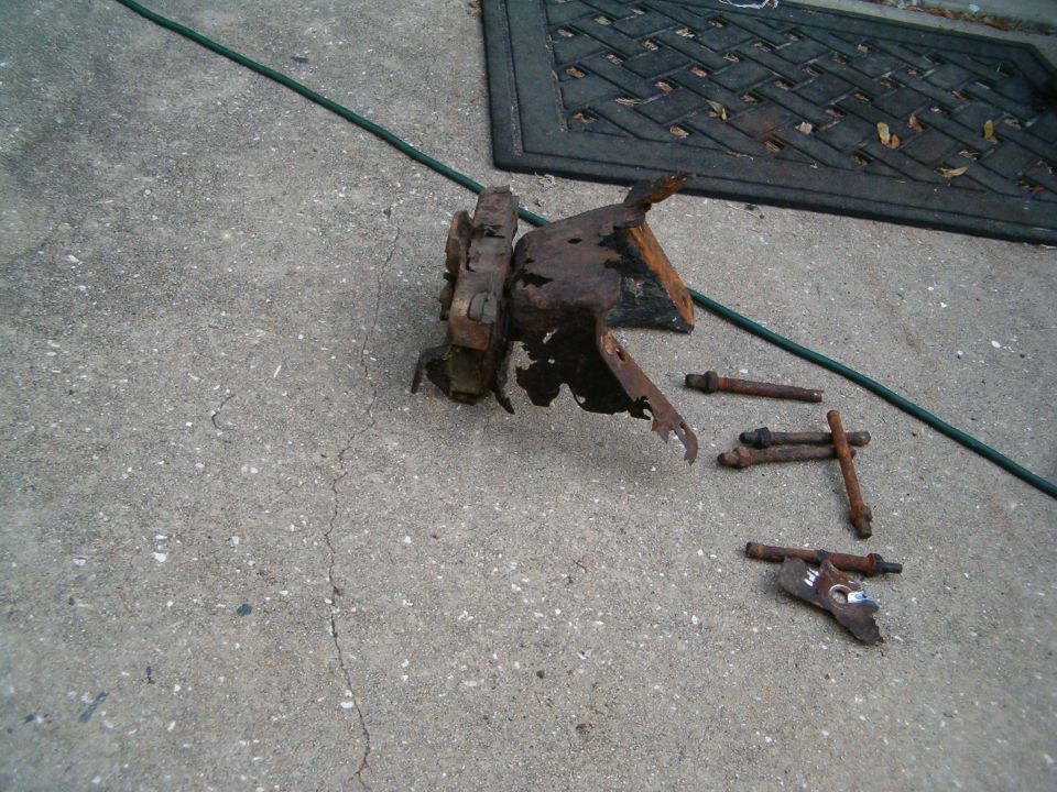 rusted metal brackets and bolts on concrete