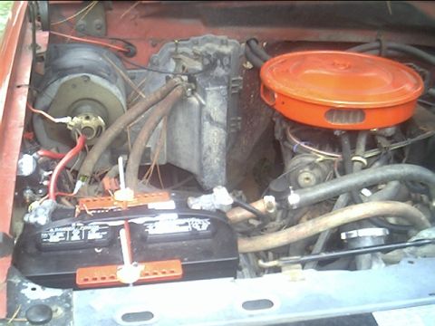 1985 Ford Bronco - Engine bay of a 1985 Ford Bronco, the battery and air cleaner assembly.