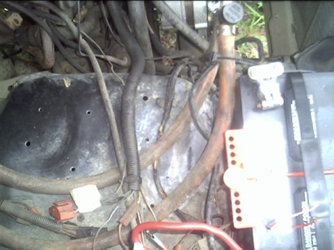 1985 Ford Bronco - A close-up view of the complex wiring and components within a vehicle's engine compartment.