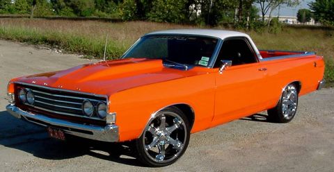 1969 Ford Ranchero - Orange 1969 Ford Ranchero with a white roof and chrome wheels parked outdoors.