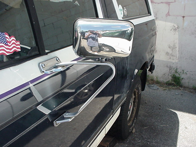 1989 Ford Bronco side mirror and door panel with American flag sticker