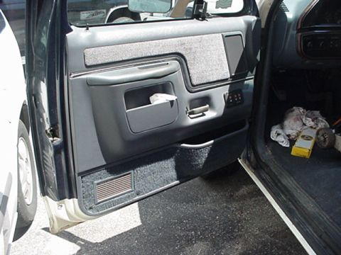 1989 Ford Bronco - Interior view of a 1989 Ford Bronco's driver's side door panel and floor area.