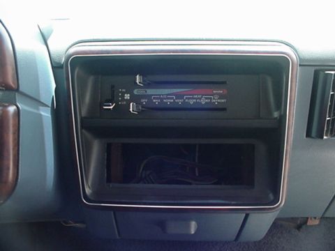 1989 Ford Bronco - Interior view of the climate controls and empty radio slot in a 1989 Ford Bronco.