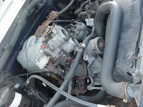 1989 Ford Bronco - Close-up view of an engine bay, showing various mechanical parts and hoses.