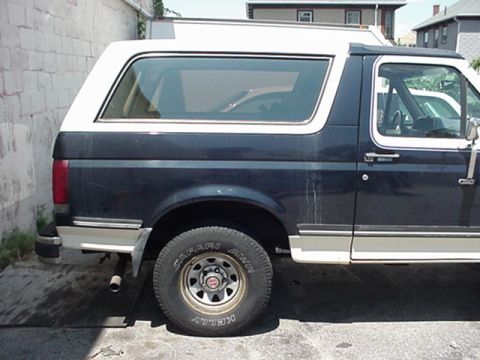 1989 Ford Bronco - This is a side view of a 1989 Ford Bronco, showing its dark blue body and white removable top.