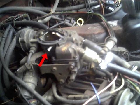 1985 Ford Bronco - A red arrow highlights a specific component on the engine's carburetor assembly.
