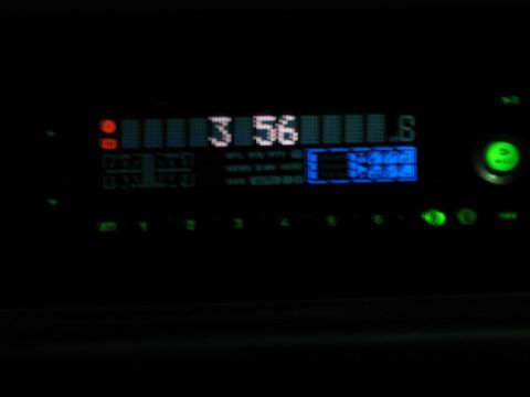 1995 Ford Bronco - Close-up of a car stereo's digital display at night, showing the time and radio station.