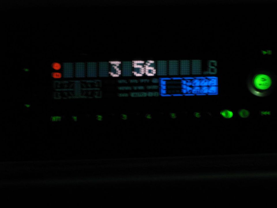 Car stereo display showing time 3:56 and radio station information