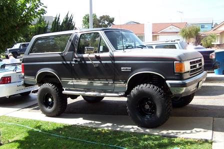 1990 Ford Bronco - This lifted 1990 Ford Bronco is parked on a residential driveway.