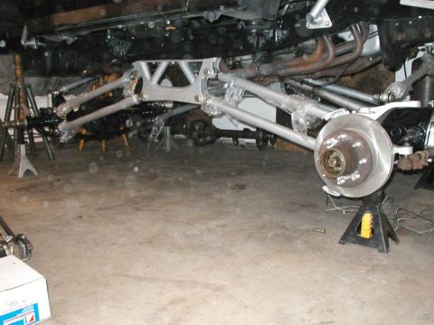 1994 Ford Bronco - Underbody view of a vehicle's suspension and drivetrain components, possibly undergoing maintenance or modification.