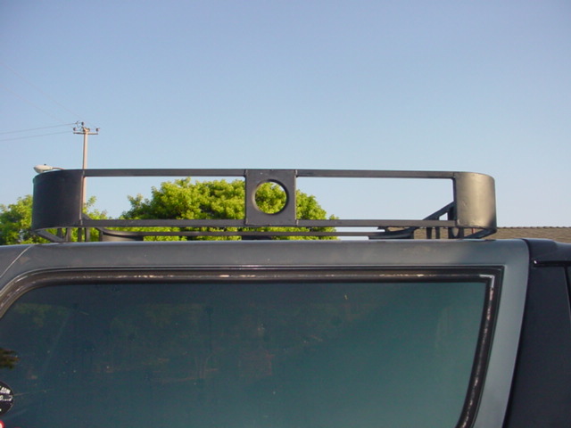 Roof rack with circular cutout on dark SUV