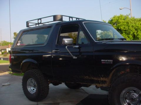 1988 Ford Bronco - Black 1988 Ford Bronco shown from the side, equipped with a roof rack.