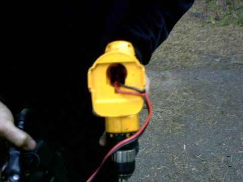 1995 Ford Bronco - A close-up view of a yellow power tool component, showing exposed red and black electrical wires.