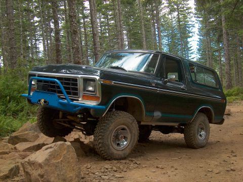 1978 Ford Bronco - This 1978 Ford Bronco is navigating a rocky trail in a wooded area.