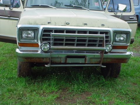 1979 Ford Bronco - This Ford truck, likely from the late 1970s, has a chrome grille guard and auxiliary lights.