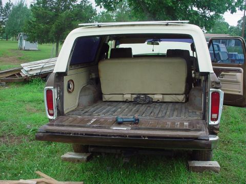 1979 Ford Bronco - This 1979 Ford Bronco is viewed from the rear with its tailgate down, revealing the cargo area and a folded-down rear seat.