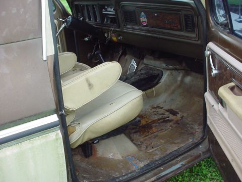 1979 Ford Bronco - Interior view of a 1979 Ford Bronco, highlighting the tan seats and the condition of the floor.