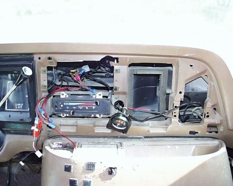 1988 Ford E250 - Exposed dashboard wiring and open dash cavities, likely during stereo installation or repair.