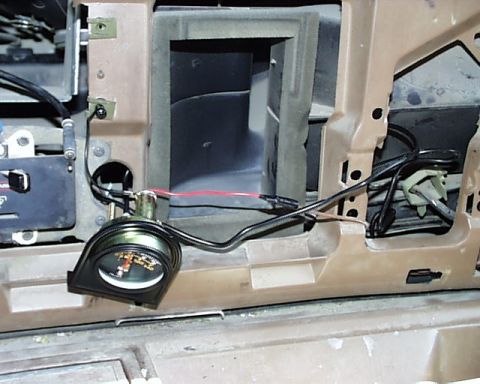 1988 Ford E250 - Aftermarket gauge installed in the dashboard of a vehicle, with visible wiring and ducting.