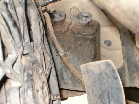 1991 Ford Bronco - Detail of a vehicle's engine bay, showing a component with hoses and caps.
