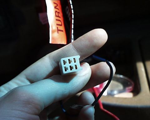 1988 Ford E250 - Close-up of a vehicle electrical connector with wires, possibly for stereo installation.