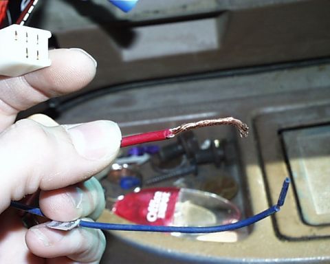 1988 Ford E250 - Close-up of exposed electrical wires and a connector, with some loose change in the background.
