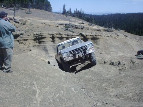 1978 Ford Bronco - A 1978 Ford Bronco navigates a steep, rocky incline during an off-road event.