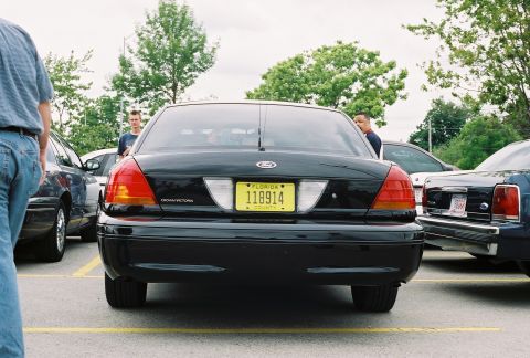 1998 Ford Crown Victoria - Rear view of a black 1998 Ford Crown Victoria parked in a lot.