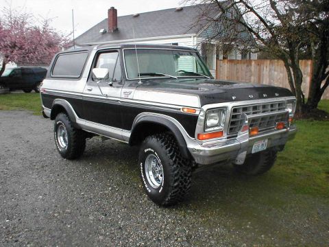 1979 Ford Bronco - This 1979 Ford Bronco features a two-tone black and silver paint scheme and aggressive off-road tires.
