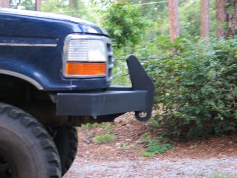 1995 Ford Bronco - Front corner view of a blue 1995 Ford Bronco an aftermarket bumper and tow hook.