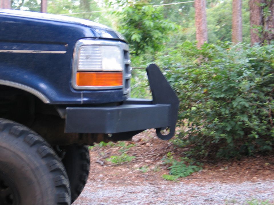 Blue 1995 Ford Bronco front corner with aftermarket bumper and tow hook