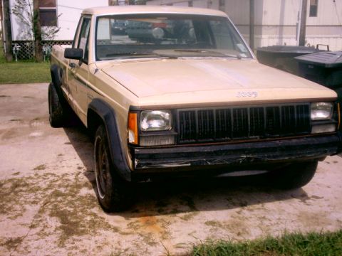1980 Ford Bronco - This Jeep Comanche pickup truck is shown from a 3/4 front angle. The vehicle appears to be from the mid-1980s.