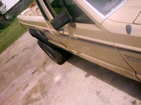 1980 Ford Bronco - Tan pickup truck with 'Comanche' badging on the door is shown from the side.