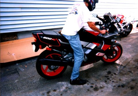 1994 Ford Bronco - A Honda CBR600F motorcycle is parked next to another motorcycle. The rider is sitting on the first bike.