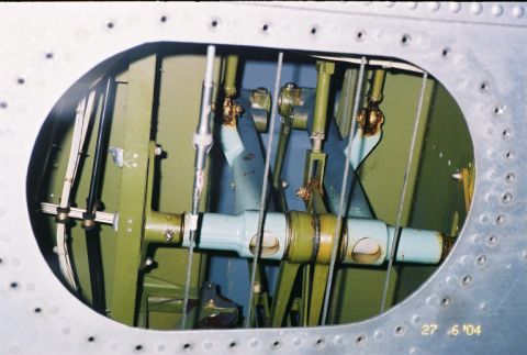 1988 Ford Bronco - Close-up view of an aircraft's internal control linkage system.