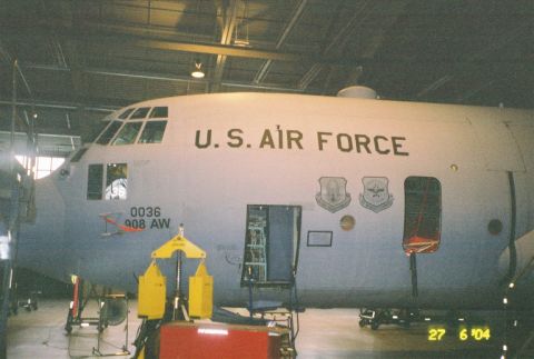 1988 Ford Bronco - A U.S. Air Force cargo plane is parked inside a hangar with its cargo door open.