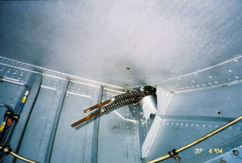 1988 Ford Bronco - Close-up view of the interior of an aircraft, showing riveted panels and exposed mechanical components.