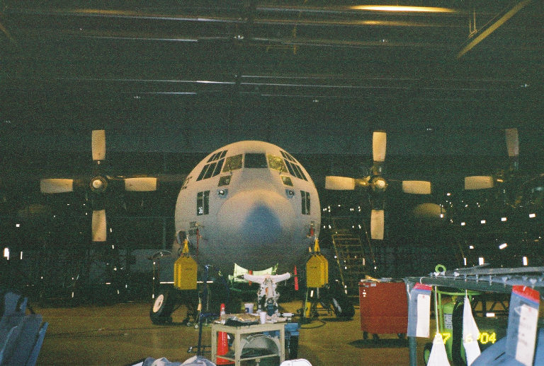 Front view of a Lockheed C-130 Hercules aircraft in a hangar