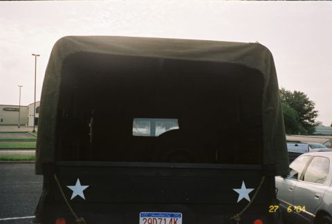 1988 Ford Bronco - This truck, a canvas top and white stars, is seen from the rear in a parking lot.