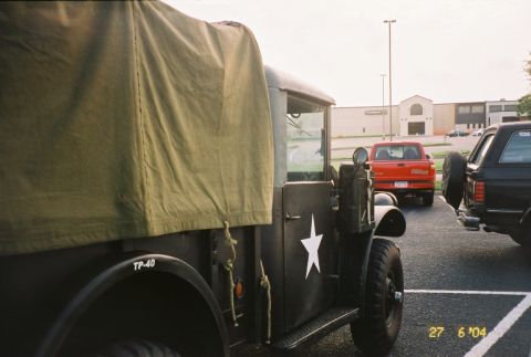 1988 Ford Bronco - A military truck is parked in a lot with other vehicles visible.