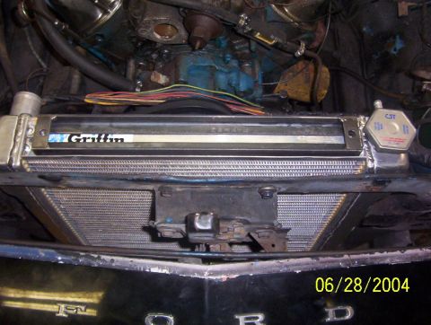 1974 Ford Mustang II - The photo shows a close-up view of a vehicle's radiator and some engine components, with a date stamp from 2004.