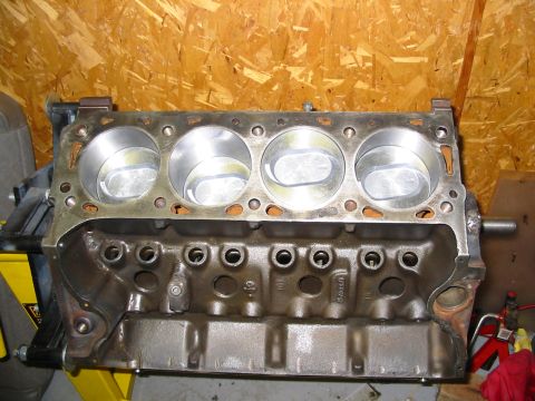 1995 Ford F-150 - Engine block with pistons, likely for a V8 engine, on a stand in a workshop.