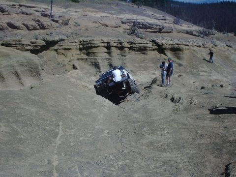 1978 Ford Bronco - Vehicle attempts to climb a challenging dirt embankment with onlookers.