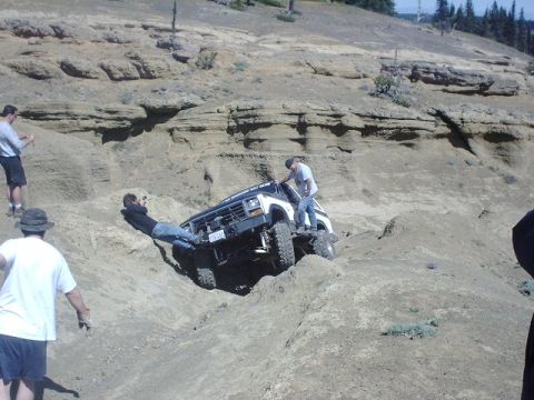 1978 Ford Bronco - People try to free an off-road vehicle stuck on a steep, rocky incline.