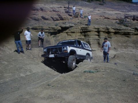 1978 Ford Bronco - Ford Bronco navigates a challenging off-road course with spectators present.
