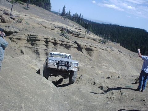 1978 Ford Bronco - 1978 Ford Bronco navigates a challenging off-road trail on a sunny day.